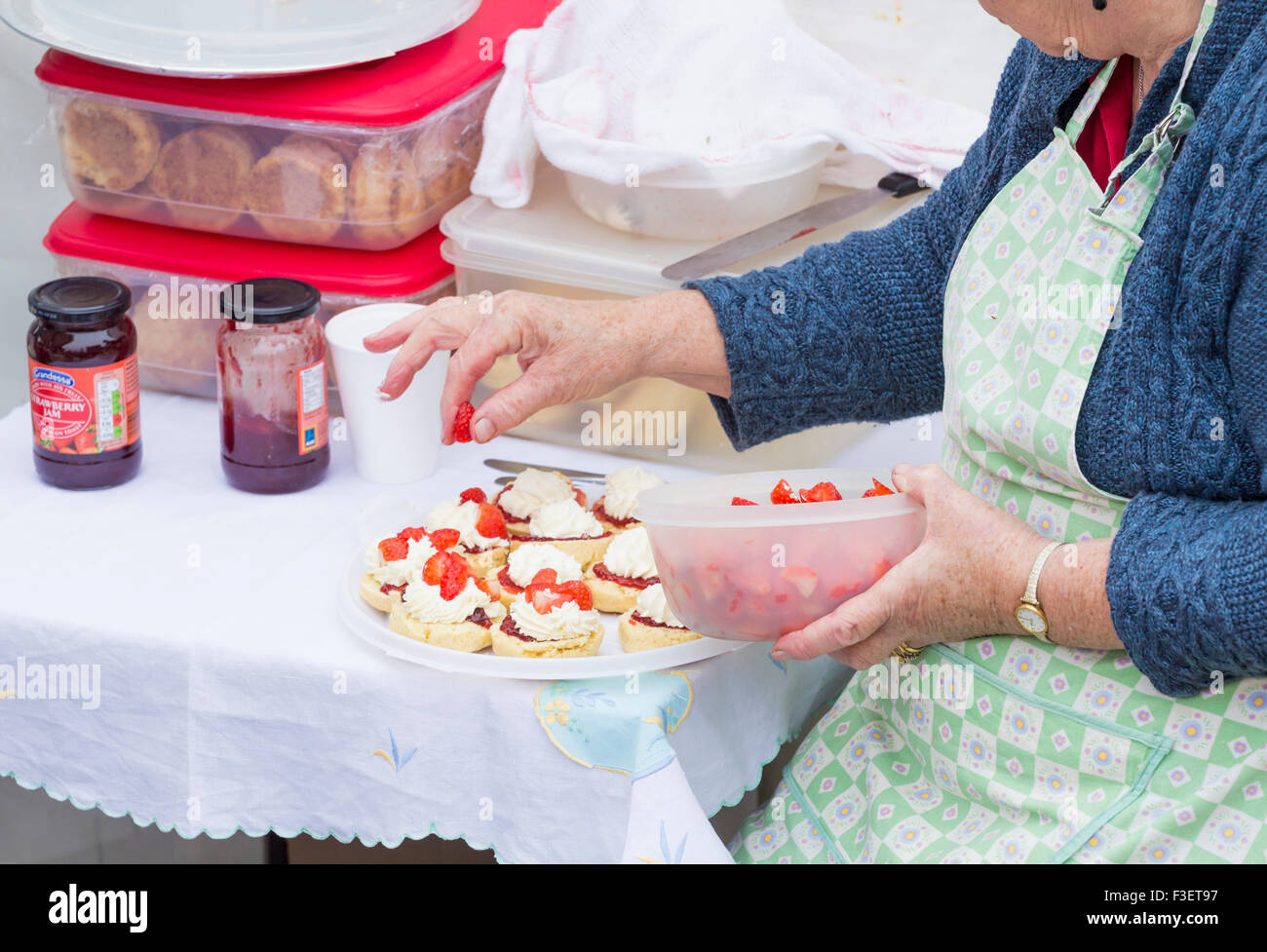 Women`s Institute members making cakes and scones on stall to sell with tea at Festival of Thrift. UK Stock Photo